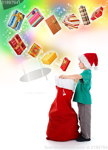 Image of Little boy opening Santa bag with wonderful presents