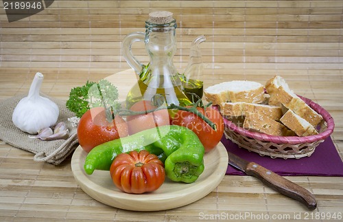 Image of still life with olive oil,vegetables on wood table 