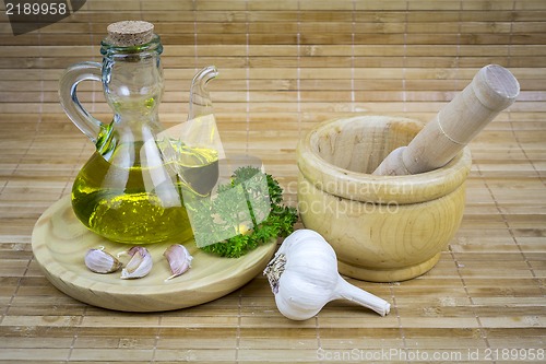 Image of still life with olive oil,vegetables on wood table 