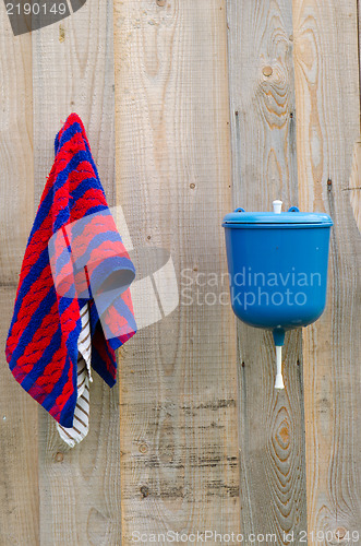 Image of rural plastic hand wash tool towel hang wood wall 