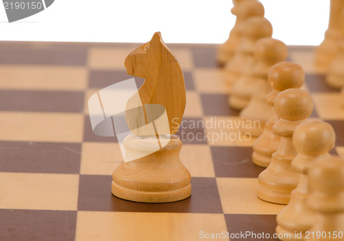Image of wooden chess figure knight stand pawn line board 