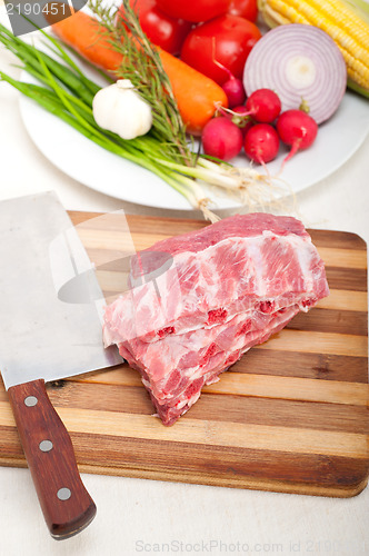 Image of chopping fresh pork ribs and vegetables