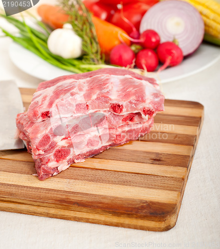 Image of chopping fresh pork ribs and vegetables
