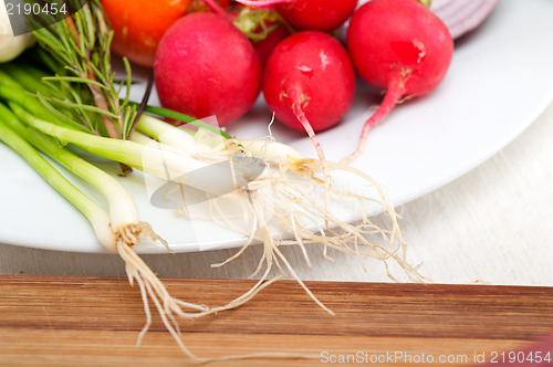 Image of fresh vegetables and herbs on a plate 