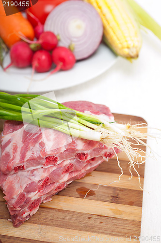 Image of chopping fresh pork ribs and vegetables