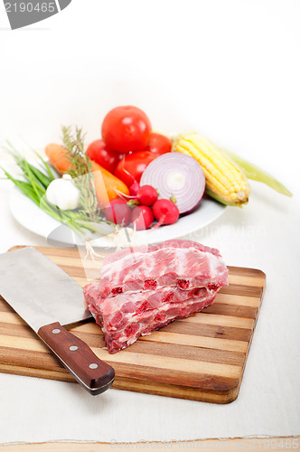 Image of chopping fresh pork ribs and vegetables