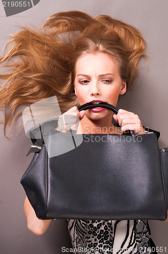 Image of Young beautiful woman with bag