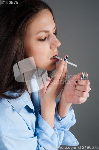 Image of beautiful young brunette woman with cigarette