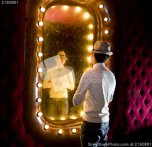 Image of retro man looks on mirror