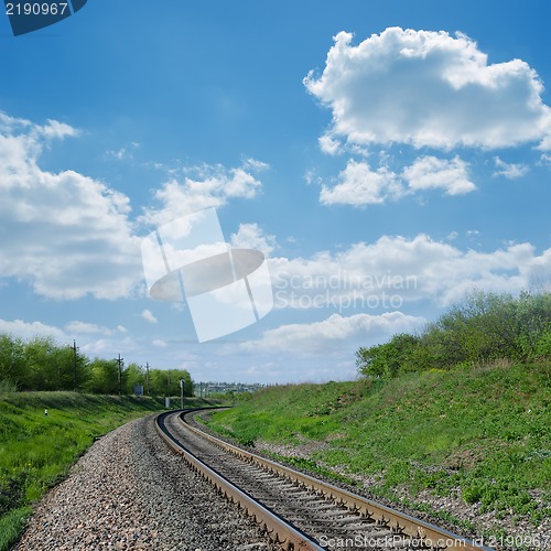 Image of railway goes to horizon in green landscape