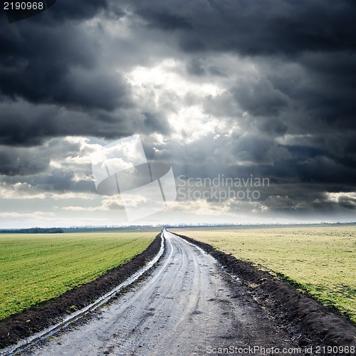 Image of dirty road to cloudy horizon
