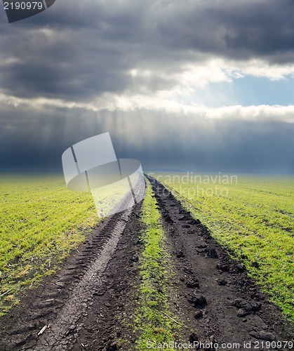 Image of dirty road to cloudy horizon