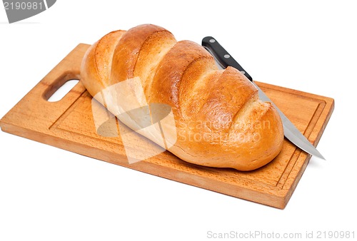 Image of fresh bread with knife on breadboard