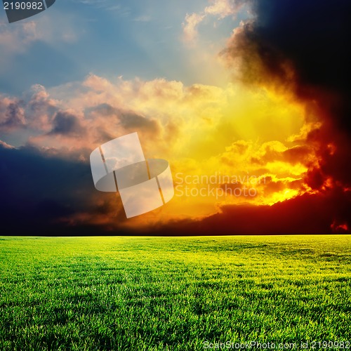 Image of sunset over green field