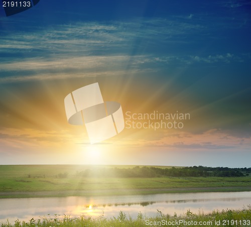 Image of sunset over field and river
