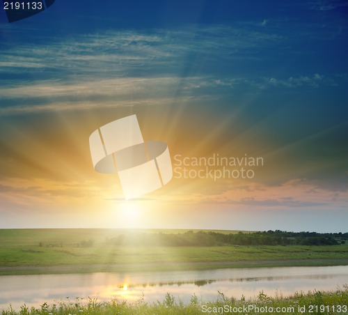 Image of sunset over field and river