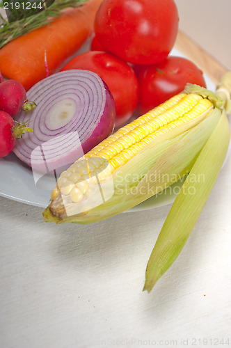 Image of fresh vegetables and herbs on a plate 