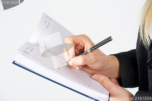 Image of Woman writing in organizer