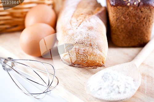 Image of bread, flour, eggs and kitchen utensil