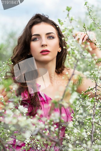 Image of Thoughtful young curly brunette