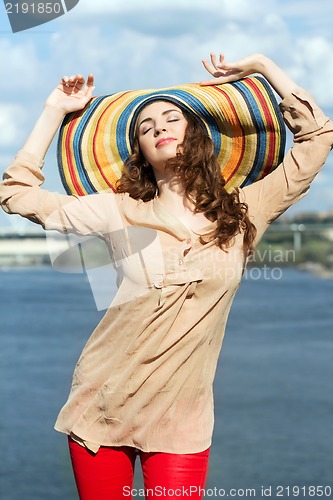 Image of Brunette wearing colorful hat