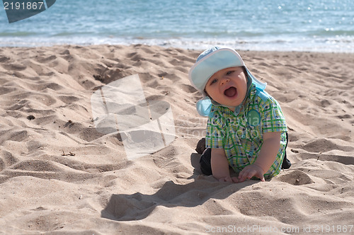 Image of Happy baby boy on the beach