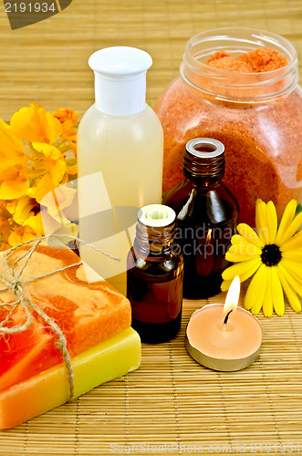 Image of Oil and lotion with flowers and candle