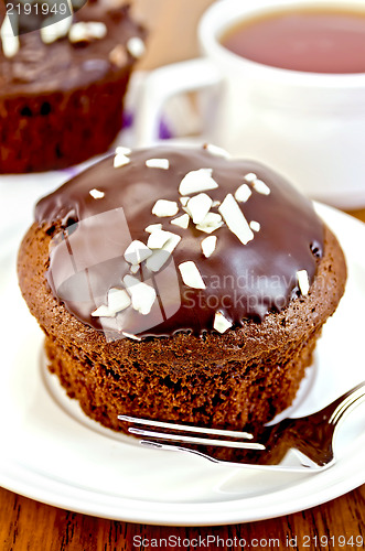 Image of Cupcake chocolate on a white plate with a fork
