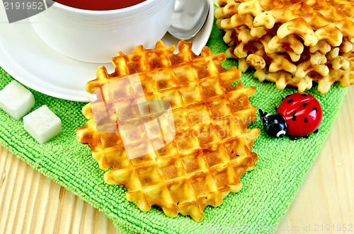 Image of Waffles circle with tea on a napkin