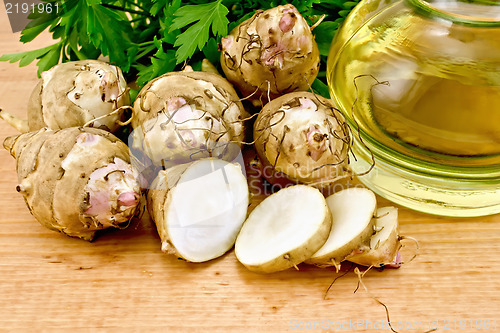 Image of Jerusalem artichokes cut with oil on board