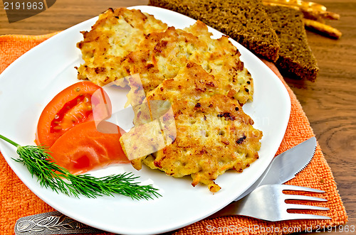 Image of Fritters chicken with vegetables and bread on a board