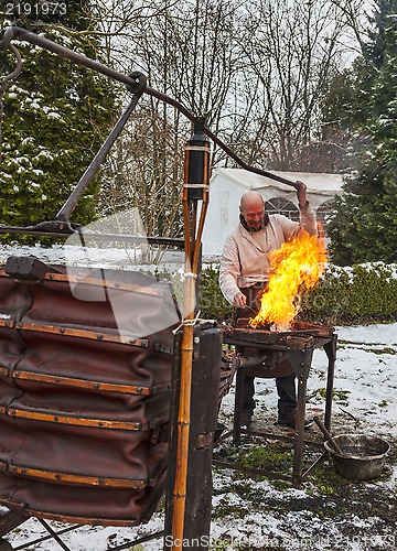 Image of The Blacksmith Working