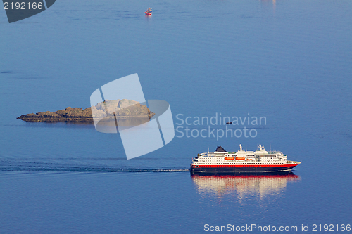 Image of Cruising ship by rock island