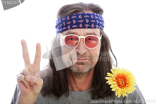 Image of Male hippie making a peace sign