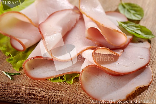 Image of Smoked meat on wooden cutting board