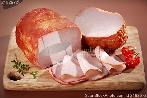 Image of Smoked meat on wooden cutting board