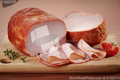 Image of Smoked meat on wooden cutting board