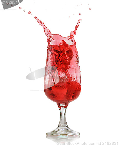 Image of red splashing drink in wine glass