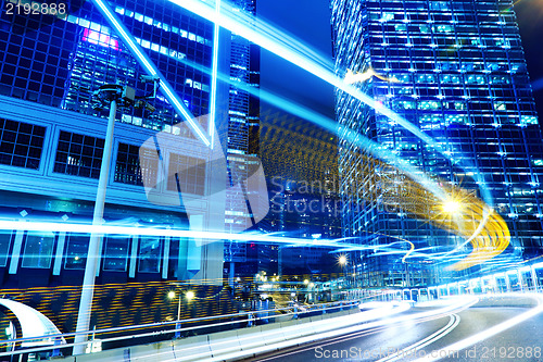 Image of moving car with blur light through city at night