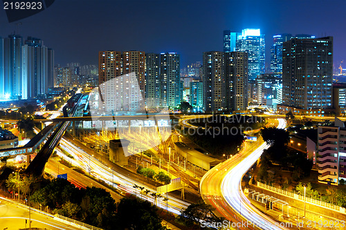 Image of city highway and traffic in city at night