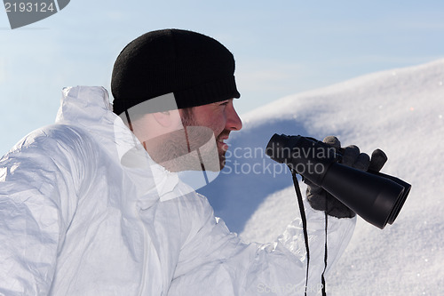 Image of Commandos  in white camouflage looking through binoculars. Portr