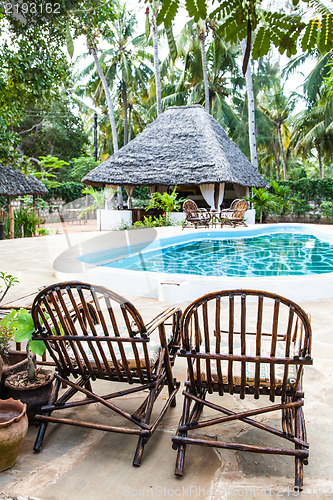 Image of Chairs on swimming pool border