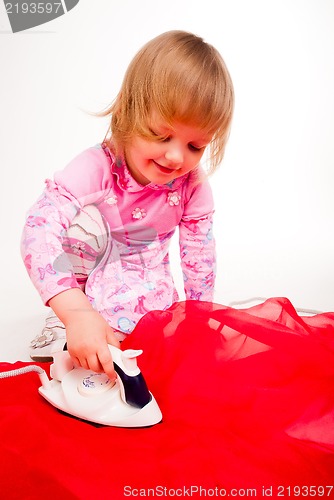 Image of little, blond hair girl ironing