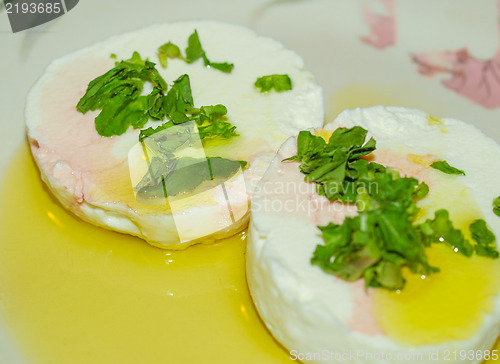 Image of Tomino cheese with rucola and olive oil