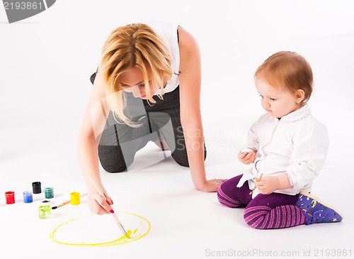 Image of Pretty young mother and daughter drawing