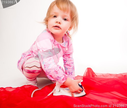 Image of little, blond hair girl ironing