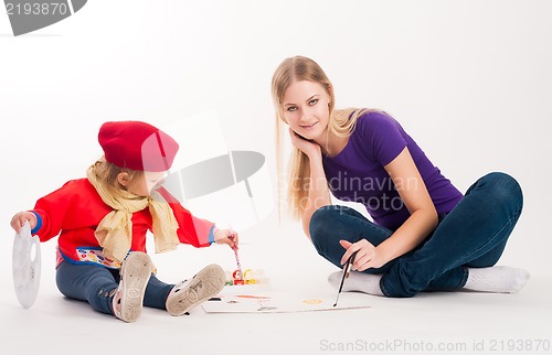 Image of Pretty young mother and daughter drawing