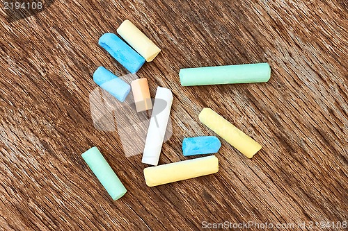 Image of Colorful chalk on the old board