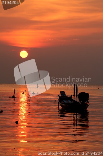 Image of Sunset with boat on tropical beach