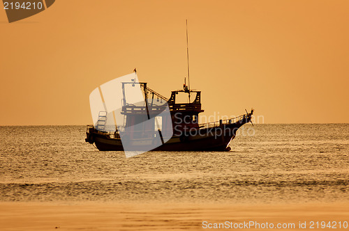 Image of Sunset with boat on tropical beach